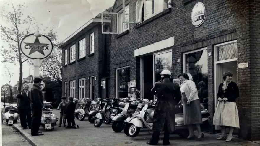 De winkel van Landewé in 1959, met scooters voor de deur